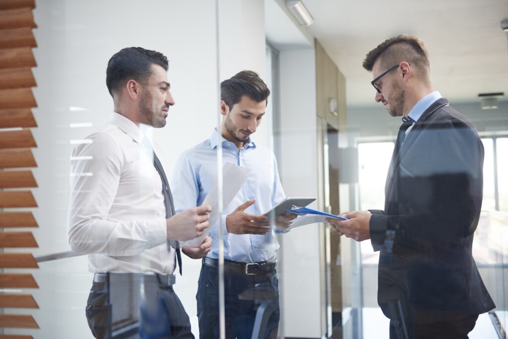 Three businessmen at their office